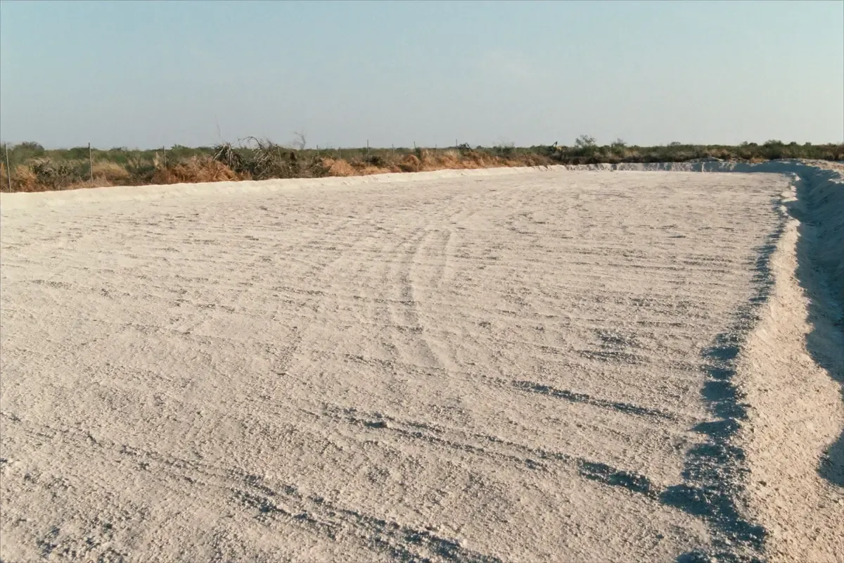 Compacted caliche building pad cut into brush country south of San Antonio, Texas