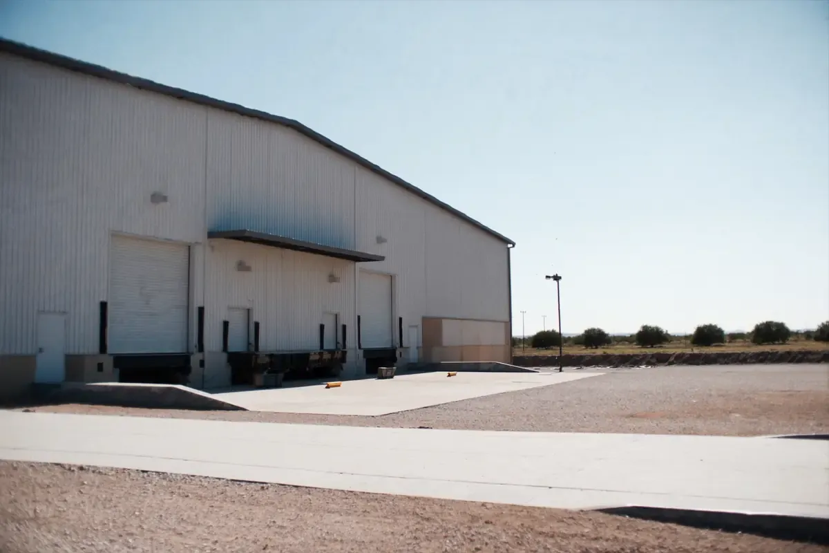 Loading docks with dock levelers along a white metal warehouse in the San Antonio area, Texas